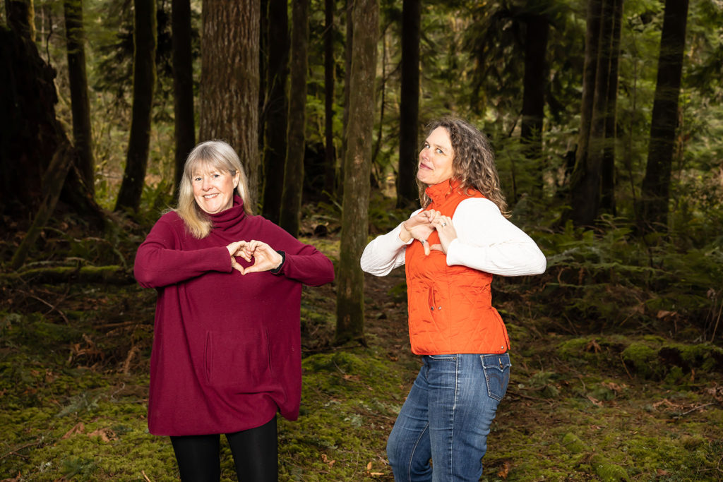 Crina and Kirsten make finger-hearts over their chests