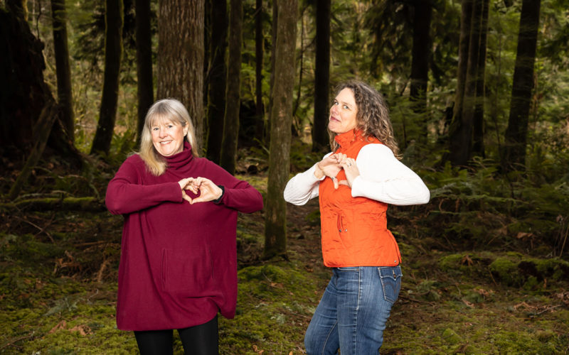 Crina and Kirsten make finger-hearts over their chests